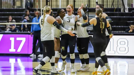 Volleyball Team Celebrates Scored Point Against Holy Cross at Gillis Field House