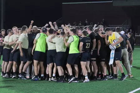 Army Men's Rugby huddles following a win at Anderson Rugby Complex
