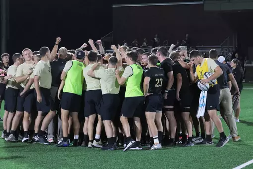 Army Men's Rugby huddles following a win at Anderson Rugby Complex