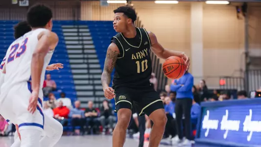 Jacen Holloway Dribbles the Ball Up the Floor Against American