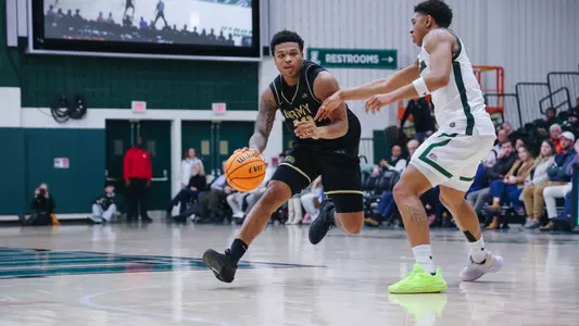 Jacen Holloway Drives the Ball Against Loyola Maryland Defender