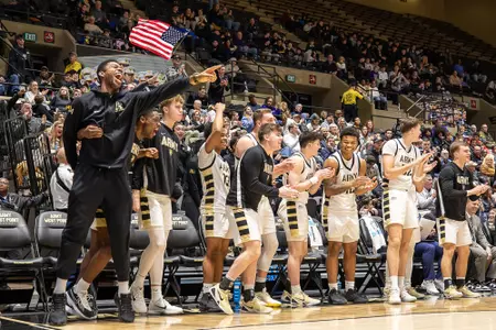 The Army Men's Basketball Bench Celebrates a Play Against Holy Cross