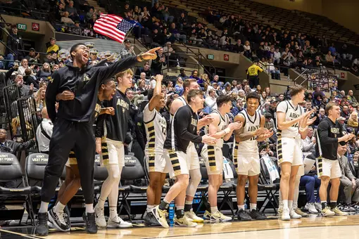 The Army Men's Basketball Bench Celebrates a Play Against Holy Cross