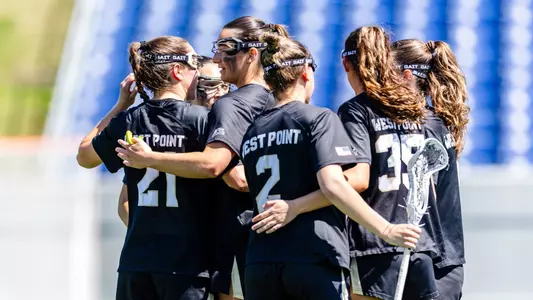 Army West Point women's lacrosse in a huddle during a game against Navy on April 11, 2026