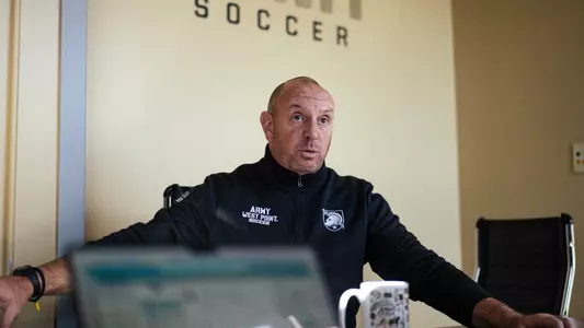 Brian Plotkin talks during team meeting