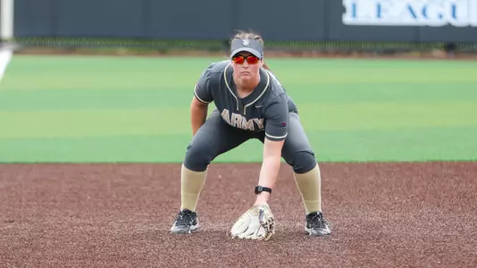 Ashton White Watches an Iona Batter in Doubleheader Action