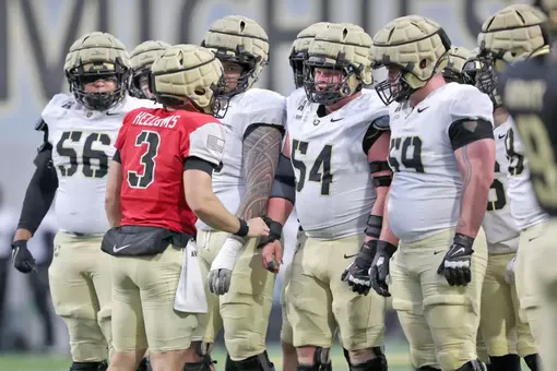 Army Football huddle with the quarterback talking to the offensive line at the 2025 Spring Game.