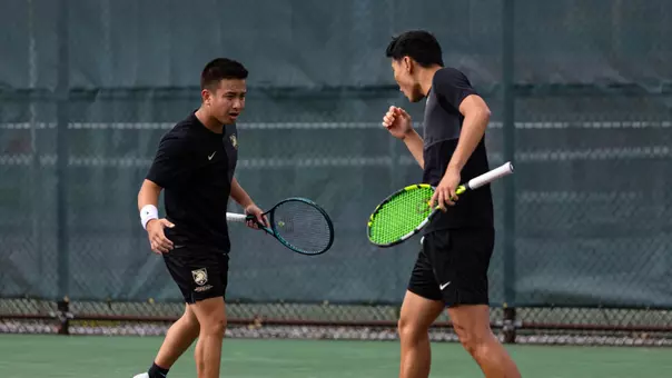 Men's Tennis doubles pair celebrates after scoring a point against Loyola Maryland at the Patriot League Quarterfinals.