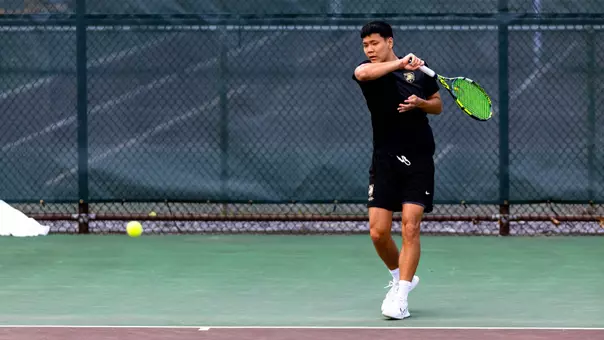 Men's Tennis player returns a ball during a rally in the Patriot League tournament.