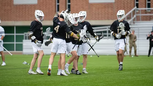 Men's Lacrosse Group hug at Penn State