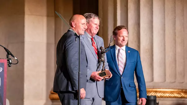 Jack Emmer and Joe Alberici stand on stage after Emer received the 2026 Spirit of Tewaaraton Award.