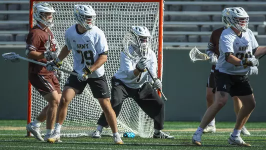 Sean Byrne stands ready in goal against Lehigh with Sam Ralston marking a defender in front of him.