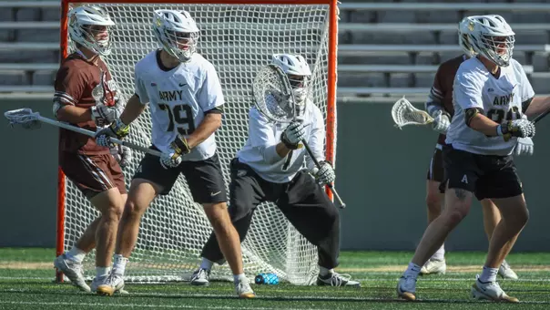 Sean Byrne stands ready in goal against Lehigh with Sam Ralston marking a defender in front of him.