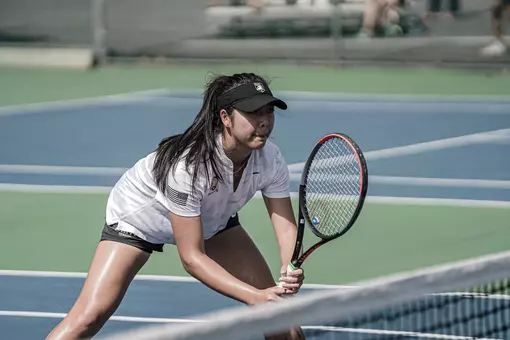 Ylan Duong gets ready before a serve during a doubles match.