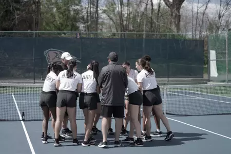 Army Women's Tennis huddles before a match.
