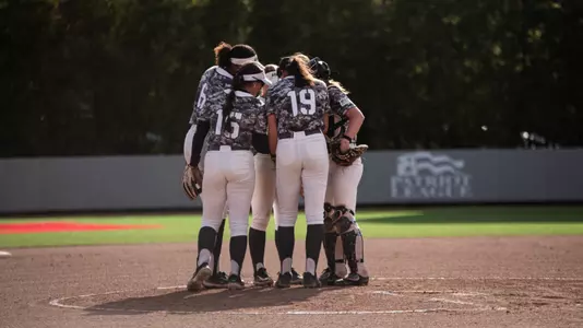Softball team huddles at the circle during their game against Colgate.