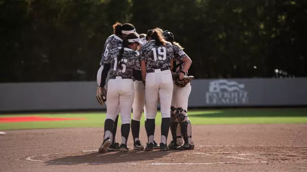 Softball team huddles at the circle during their game against Colgate.