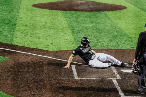 Josiah Overbeek slides for a run in Army's postseason opener.