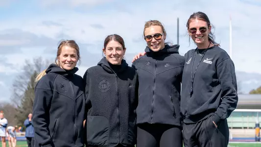 Noto Family Head Coach Michelle Tumolo, Associate Head Coach Sammy Cermack and Assistant Coaches Charlotte Sofield and Jordan Dean pose for a photo before a game at Bucknell on March 21, 2026