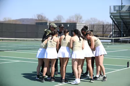 The Army Women's Tennis team huddles before a match in 2026.