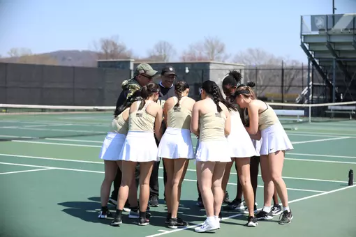 The Army Women's Tennis team huddles before a match in 2026.