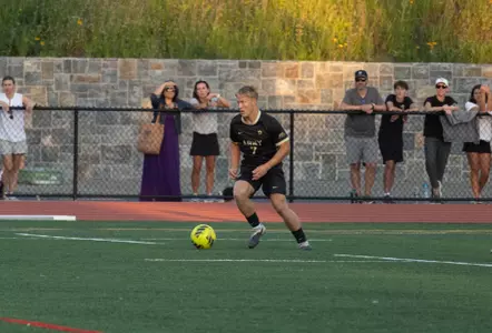 Riley Cullum Kicks Soccer Ball in Men's Soccer Game