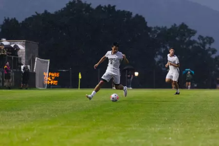 Kasem Minzey kicks soccer ball in season opener against Air Force