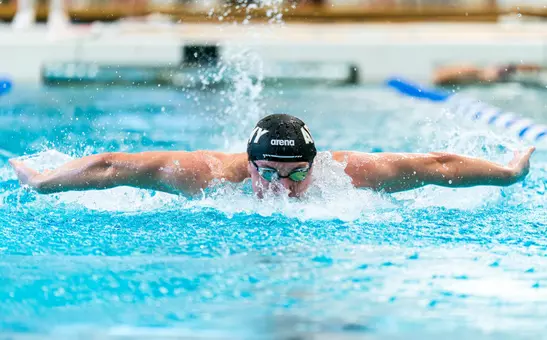 Army West Point Swimmer swims in a pool for a competition