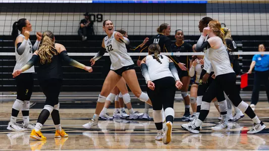 Volleyball Celebrates a Point Against UAlbany in Christl Arena