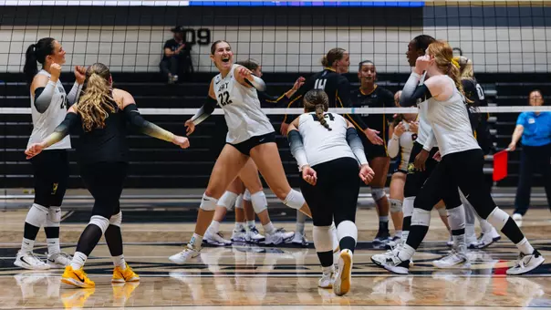 Volleyball Celebrates a Point Against UAlbany in Christl Arena