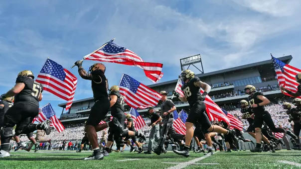 Sep 12, 2026; West Point, New York, USA; The Army Black Knights take the field holding American flags in memory of September 11th (9/11) victims before a game against the South Florida Bulls at Michie Stadium. Mandatory Credit: Danny Wild-Imagn Images