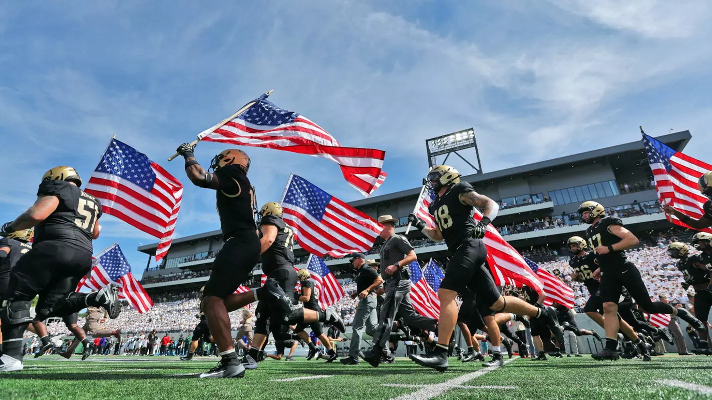 Sep 12, 2026; West Point, New York, USA; The Army Black Knights take the field holding American flags in memory of September 11th (9/11) victims before a game against the South Florida Bulls at Michie Stadium. Mandatory Credit: Danny Wild-Imagn Images
