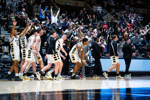Men's Basketball Bench Celebrates Win over Holy Cross