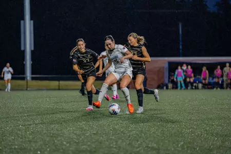Women's Soccer's Megan Youngberg and Blanca Webb chase down opponent in Orono, Maine