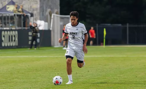 Men's soccer player Kasem Minzey kicks soccer ball during a match