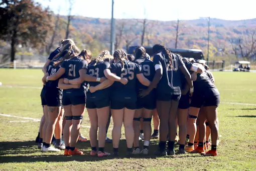 Women's Rugby team huddles on field before game