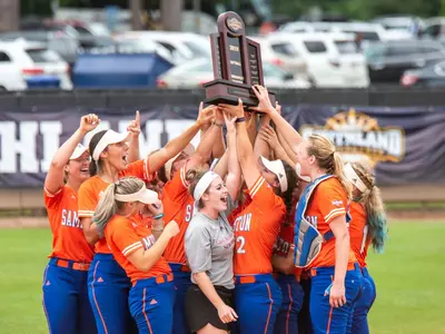 Bearkats celebrate SLC softball tournament victory.