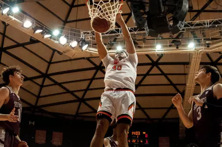 Kian Scroggins dunks against MO State
