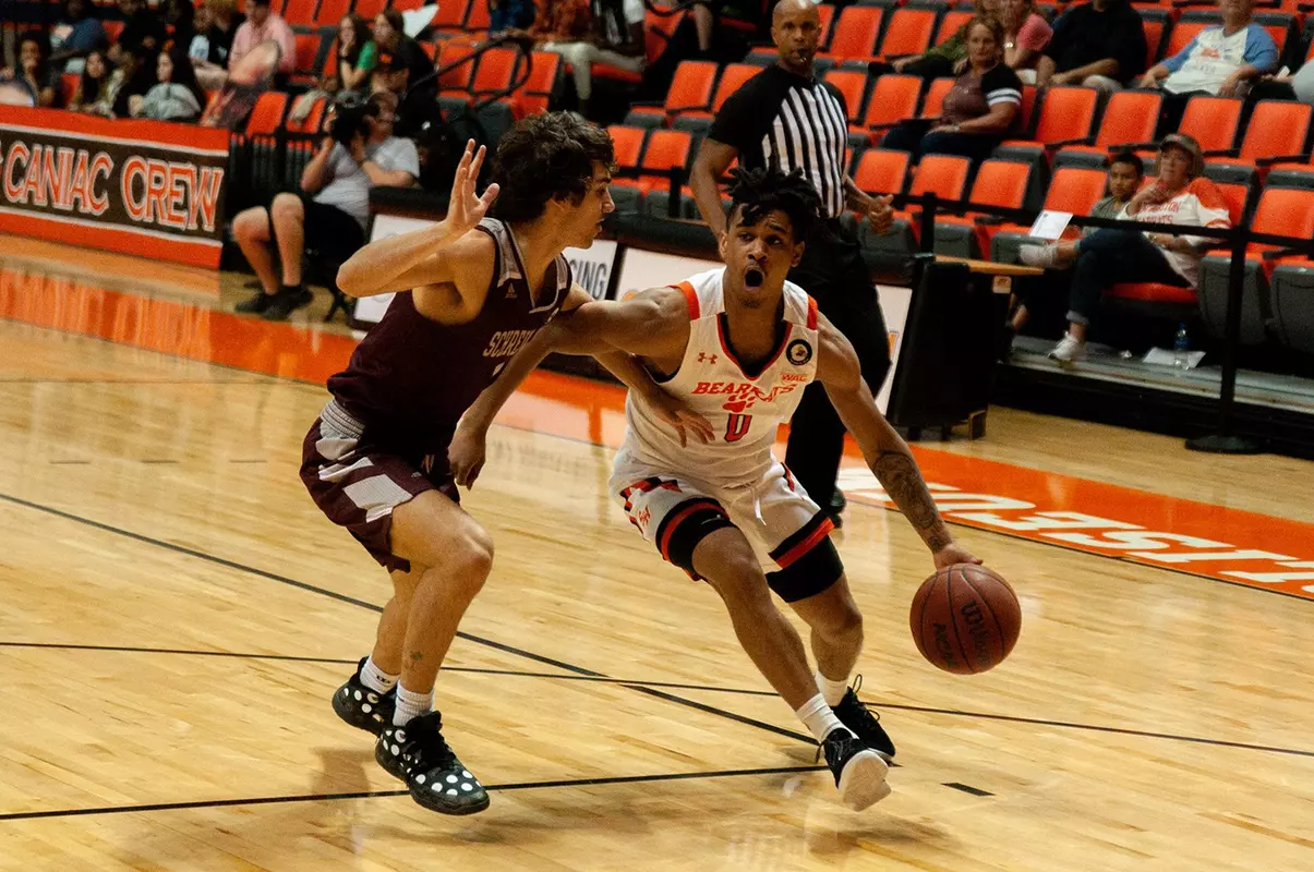 Javon Grant drives baseline against Schreiner
