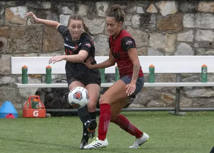 Grace Stine plays the ball against IUW