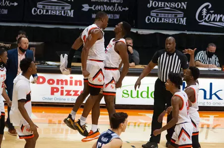 Zach Nutall and Demarkus Lampley celebrate against Rice