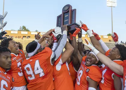 Football holds up 2021 SLC trophy