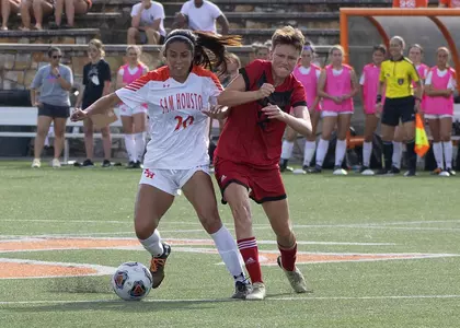 Ashley Friedrichs battles with a Grambling player for the ball.