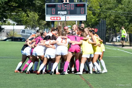 Soccer team huddles