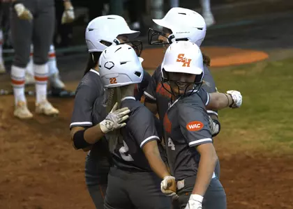 Softball celebrates at home plate