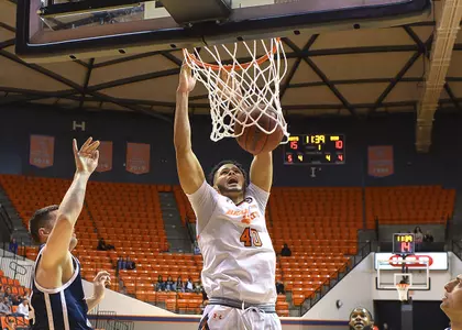 Kian Scroggins dunks against Dixie State