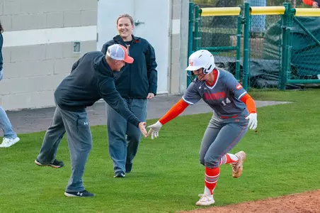 Coach Valis celebrates a home run with Bailey Wasik