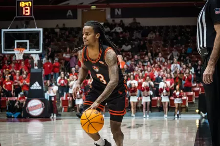 Lamar Wilkerson dribbles against SUU