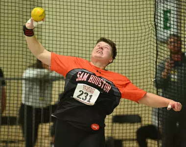 Lilly Rodel competes in the shot put at an indoor meet