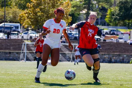 Solae Young dribbles against at WKU player